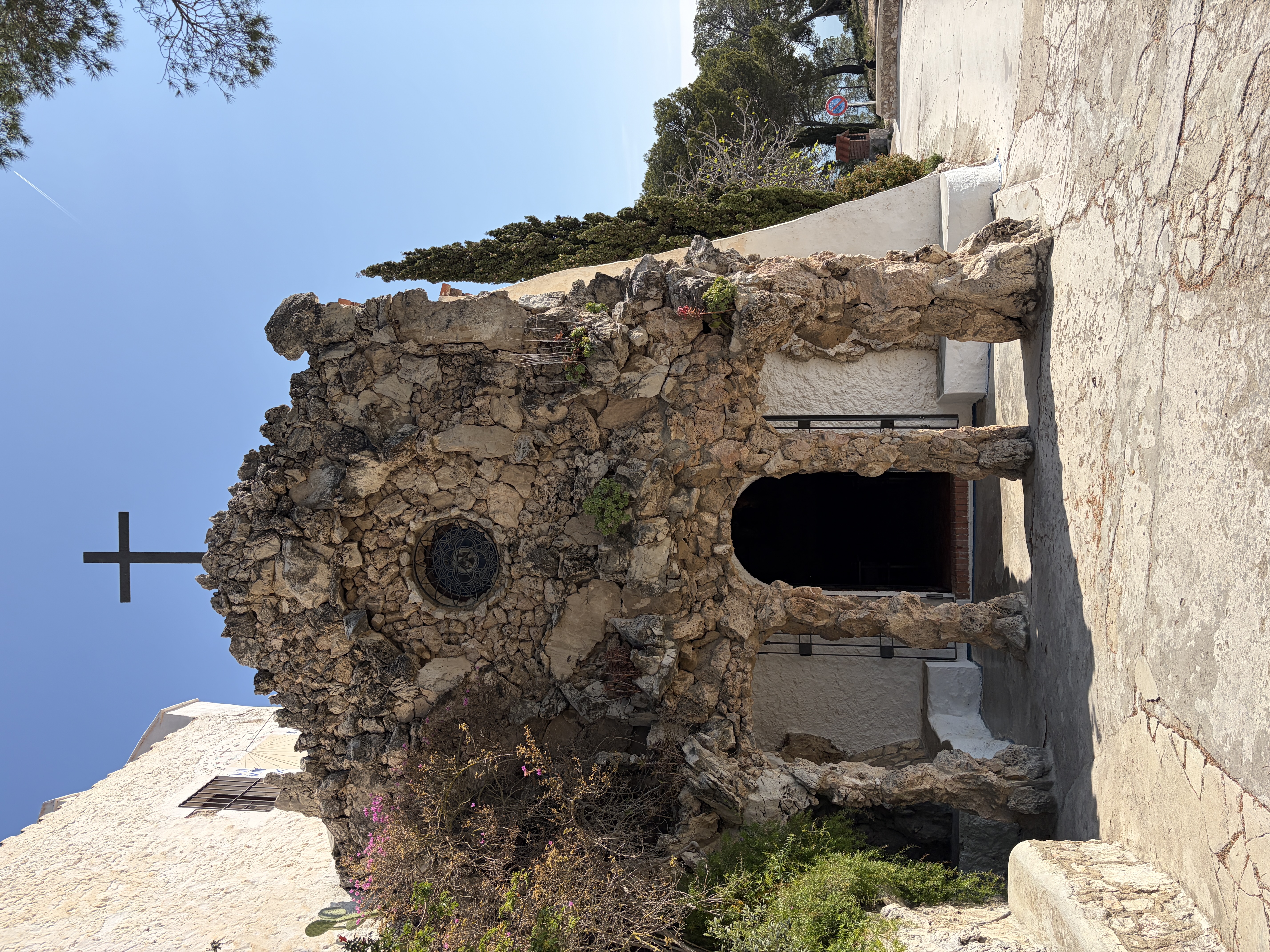 The facade of the Ermita de la Trinitat with its stone stairway and rustic tower
