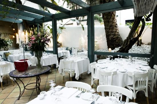 The candlelit garden terrace at Al Fresco, Carrer Pau Barrabeig, Sitges